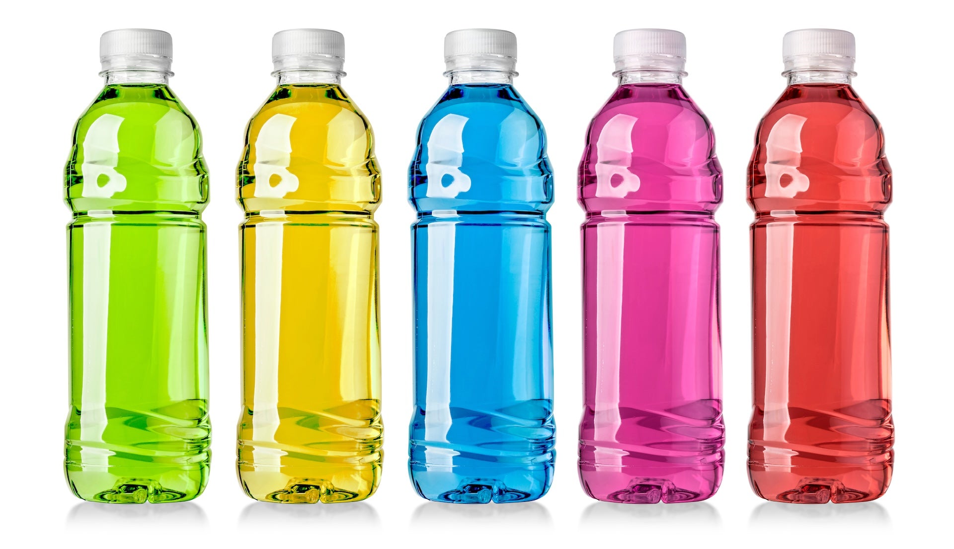 Five clear plastic bottles filled with brightly colored sports drinks (green, yellow, blue, magenta, red) lined up on a white background